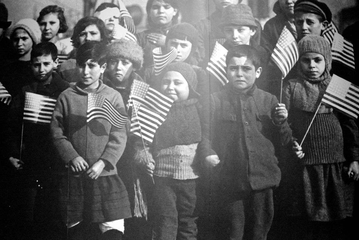 12-17 Photograph Of Young Children Waving The Flag Of Their New Country Ellis Island Main Immigration Station Building